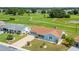 Single-story home with a paved driveway and golf course views at 609 Fox Hills Dr, Sun City Center, FL 33573