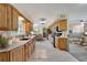 Spacious kitchen featuring wood cabinets, modern appliances, and a breakfast bar at 609 Fox Hills Dr, Sun City Center, FL 33573