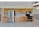 Well-lit kitchen featuring stainless steel appliances, tile flooring, and ample cabinet space at 609 Fox Hills Dr, Sun City Center, FL 33573