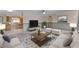 Inviting living room with a plush sectional sofa, stylish rug, and ample natural light at 609 Fox Hills Dr, Sun City Center, FL 33573
