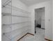 Walk-in pantry with ample wire shelving for organized storage solutions, adjacent to the kitchen area at 609 Fox Hills Dr, Sun City Center, FL 33573