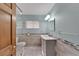 Updated bathroom with walk-in shower and gray vanity at 609 Fox Hills Dr, Sun City Center, FL 33573