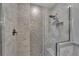Luxurious shower with rain showerhead, built-in seat, and decorative mosaic tile at 609 Fox Hills Dr, Sun City Center, FL 33573