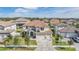 Aerial view of home with tile roof, three-car garage, and landscaped yard at 7134 Heather Sound Loop, Wesley Chapel, FL 33545