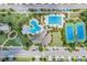 Aerial view of community amenities with a pool, tennis court, and clubhouse at 7134 Heather Sound Loop, Wesley Chapel, FL 33545