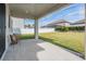 Covered patio with seating area overlooks fenced backyard at 7134 Heather Sound Loop, Wesley Chapel, FL 33545