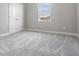 Empty bedroom with closet, gray carpet and window at 7134 Heather Sound Loop, Wesley Chapel, FL 33545