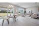 Dining area adjacent to living room with sliding doors to the backyard at 7134 Heather Sound Loop, Wesley Chapel, FL 33545