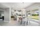 Open concept dining room with view of the kitchen and backyard access at 7134 Heather Sound Loop, Wesley Chapel, FL 33545