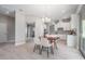 Dining space with modern table and chairs and a view into the kitchen area at 7134 Heather Sound Loop, Wesley Chapel, FL 33545