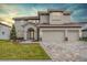 Beautiful two-story home with a three-car garage and a paved driveway at 7134 Heather Sound Loop, Wesley Chapel, FL 33545