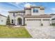 Two-story home with a three-car garage, stone accents, and a tile roof at 7134 Heather Sound Loop, Wesley Chapel, FL 33545