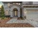Inviting front entry with double doors, paved walkway, and attached two-car garage at 7134 Heather Sound Loop, Wesley Chapel, FL 33545