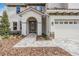 Front entry with arched doorway, stone accents, and a paver walkway at 7134 Heather Sound Loop, Wesley Chapel, FL 33545