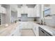 Well-appointed kitchen with white cabinetry, stainless steel appliances, and a large island at 7134 Heather Sound Loop, Wesley Chapel, FL 33545