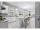 Modern kitchen with island seating, stainless steel appliances, and open access to dining area at 7134 Heather Sound Loop, Wesley Chapel, FL 33545