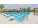 Large lap pool with starting blocks, offering a dedicated space for swimming enthusiasts at 7134 Heather Sound Loop, Wesley Chapel, FL 33545