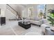Open and airy living room with large windows, comfortable seating, and stylish decor at 7134 Heather Sound Loop, Wesley Chapel, FL 33545