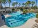 Community pool with lap lanes, water features, and a shaded seating area at 7134 Heather Sound Loop, Wesley Chapel, FL 33545