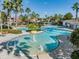 Community pool with water features, lounge chairs, and palm trees at 7134 Heather Sound Loop, Wesley Chapel, FL 33545