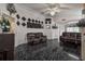 Living room with dark leather couches, a tiled floor, and a ceiling fan at 6108 Lanshire Dr, Tampa, FL 33634