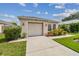 Front view of a single-story house with a garage and neatly landscaped front yard at 6108 Lanshire Dr, Tampa, FL 33634