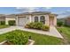 House exterior featuring a one-story home with a garage and well-manicured landscaping at 6108 Lanshire Dr, Tampa, FL 33634