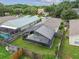 Aerial view of a backyard with a screened patio, pool, and fenced yard at 6108 Lanshire Dr, Tampa, FL 33634