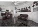 Spacious living room with dark leather furniture and a view into the kitchen area at 6108 Lanshire Dr, Tampa, FL 33634