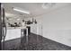 Kitchen boasting black appliances, white cabinetry, and a view to the living room at 6108 Lanshire Dr, Tampa, FL 33634