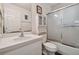 Bathroom features a white vanity, tub, and frosted glass shower door at 6108 Lanshire Dr, Tampa, FL 33634