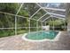 Inviting screened pool area with brick pavers and lush landscaping at 10538 San Travaso Dr, Tampa, FL 33647