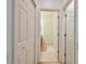 A light and bright hallway with access to multiple rooms and closets at 2303 Hannah N Way, Dunedin, FL 34698