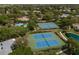 Aerial view of community amenities including tennis courts and a pool at 1134 S Pointe Alexis Dr, Tarpon Springs, FL 34689