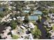 Aerial view showing community pool, tennis courts, and waterfront homes at 1134 S Pointe Alexis Dr, Tarpon Springs, FL 34689