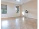 Spacious living room with tile floors and neutral walls at 1134 S Pointe Alexis Dr, Tarpon Springs, FL 34689