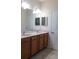 Double vanity with wood cabinets and marble countertop at 1134 S Pointe Alexis Dr, Tarpon Springs, FL 34689