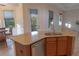 Kitchen island with granite countertop, sink, and dishwasher at 1134 S Pointe Alexis Dr, Tarpon Springs, FL 34689