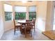 Bright dining area with a round table and four chairs, near large windows at 1134 S Pointe Alexis Dr, Tarpon Springs, FL 34689