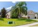 Single-Gathering home with palm tree and lawn at 1134 S Pointe Alexis Dr, Tarpon Springs, FL 34689