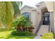 House exterior showcasing a front entrance with stairs and landscaping at 1134 S Pointe Alexis Dr, Tarpon Springs, FL 34689