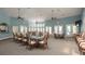 Community room with tables, chairs, and plenty of natural light at 1134 S Pointe Alexis Dr, Tarpon Springs, FL 34689