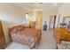 Bedroom with wood furniture, ensuite bathroom access, and walk-in closet at 1134 S Pointe Alexis Dr, Tarpon Springs, FL 34689