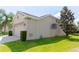 Tan house with garage and manicured lawn at 1134 S Pointe Alexis Dr, Tarpon Springs, FL 34689