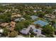 Aerial view of community with pool, tennis courts, and lush landscaping at 1134 S Pointe Alexis Dr, Tarpon Springs, FL 34689