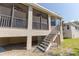 Screened porch with stairs leading to the ground at 1134 S Pointe Alexis Dr, Tarpon Springs, FL 34689