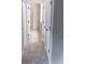 View down a hallway to a bathroom and other rooms at 1134 S Pointe Alexis Dr, Tarpon Springs, FL 34689