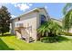 House exterior with wooden stairs and landscaping at 1134 S Pointe Alexis Dr, Tarpon Springs, FL 34689