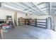 Garage with storage shelving and stairs to upper level at 1134 S Pointe Alexis Dr, Tarpon Springs, FL 34689