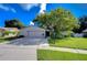 Charming house exterior with a two-car garage and lush landscaping at 4008 Greenmark Ln, Valrico, FL 33596